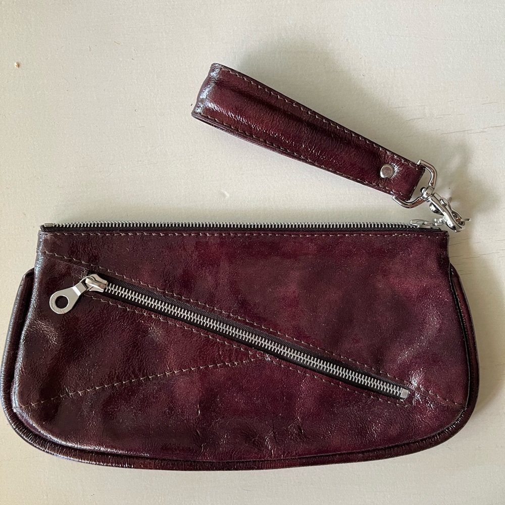 Mint condition Christopher Kon leather clutch in plum high-shine leather.